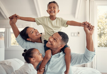 Mother, father and kids, a happy family playing on bed in home, smile and laugh with piggy back on holiday weekend. Love, fun and family time for dad, mom and children in family bedroom in Brazil. - obrazy, fototapety, plakaty