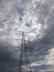 Tower SUTET or extra high voltage airways with a very dark cloudy sky background.