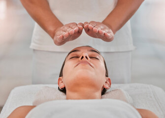 Relax, health and reiki with woman on spa table for healing energy, zen and alternative medicine....