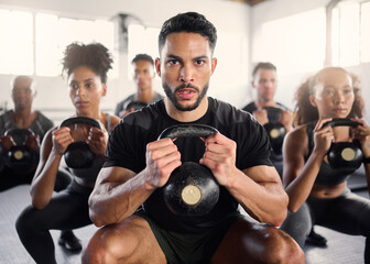 Squat, kettlebell and fitness coach in a gym exercise, power and workout wellness class. Portrait of a sport personal trainer with focus on training people for health goals and sports cardio