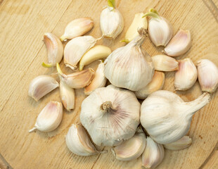Garlic bulbs and cloves on a wooden cutting board