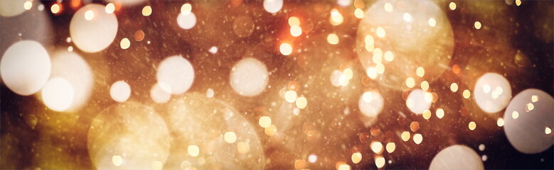 Abstract light celebration background with defocused golden lights for Christmas, New Year,...
