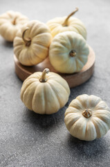 Autumn leaves and pumpkins over  grey concrete background