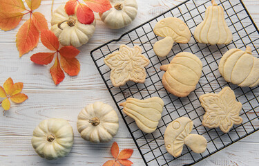 Autumn baking. Cookies in the form of pumpkin and leaves on the table.