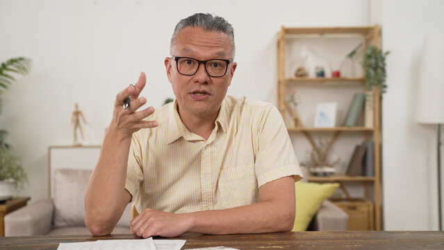 Head shot asian employer lead job interview with applicant laptop screen teleconference app view. old Businessman talk with client by video call communicating distantly use modern videoconference