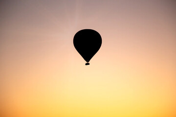 Helium balloon is shinning behind of sun.