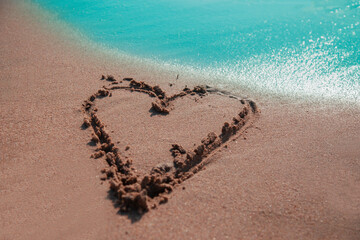 Heart shape on the sand during holiday.