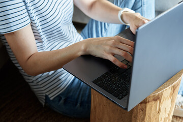 Fototapeta premium Working from home concept. Woman jands typing on laptop keyboard. Remote work from home workplace