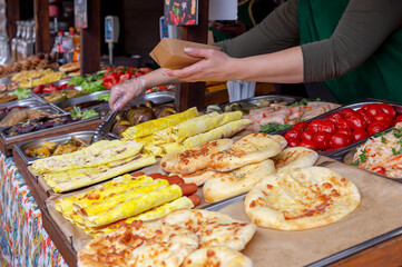 A lot of different food. Hands of the seller