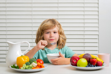 Child eating meal. Healthy nutrition for children. Cute boy enjoy eating for morning breakfast with appetite. Hungry child eat tasty fruits and vegetables.