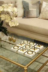 Golden tic tac centerpiece on a living room side table