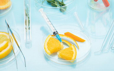 Laboratory glassware with plants and citrus fruits