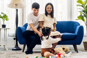 Portrait of enjoy happy love asian family father and mother with little asian girl smiling activity...