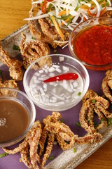 Crispy squid tentacles pick up food with various sauces