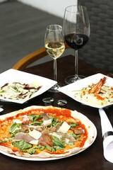 Proscuitto arugula pizza with risotto di gamberi and a chocolate syrup dessert