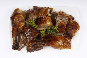 Chopped roasted chicken served on a white plate