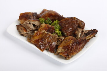 Chopped roasted chicken served on a white plate