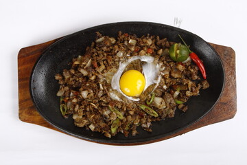 Pork sisig, a Filipino dish, served on a sizzling plate