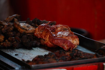 Meat and sausages on the grill. Prepared from meat with a delicious taste. Appetizing sausages. Detail photo.
