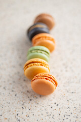 Sweet macaron dessert. Colorful macarons on kitchen table.