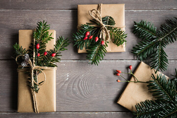 Naturally wrapped Christmas presents decorated with spruce twigs - 545854871