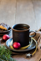 Studio shot of cup of coffee with twigs, Christmas ornaments and gingerbread - 545854899