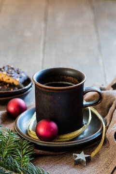 Studio shot of cup of coffee with twigs, Christmas ornaments and gingerbread