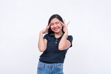 A cheerful asian woman thinking of happy thoughts. Hands on temple reacting after being...