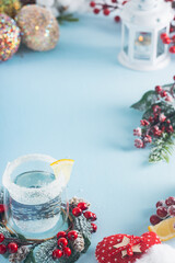 Sparkling drink with Christmas decorations, snow, candles, glitter, blue, white, red banner, background, frame