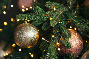 Obraz na płótnie Canvas New Year's toy. Decorated Christmas tree on a blurry, sparkling and fabulous background. Garland and bokeh. Bright Lights. defocus