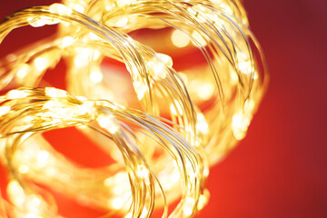 christmas beautifull shiny gold garland on a red background. sparkle festive background