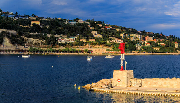 Lighthouse and luxury boats in the bay on the Mediterranean Sea in Villefranche sur Mer Old Town on the French Riviera, South of France