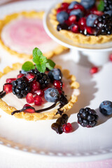 Close up Aufnahme von Mini Törtchen Tarts mit Beeren