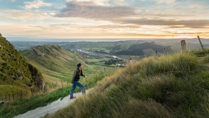 Man hiking Te Mata Peak track. Climbing steep uphill, Hawke’s Bay. - Powered by Adobe