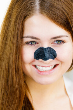 Woman Applying Pore Strips On Nose