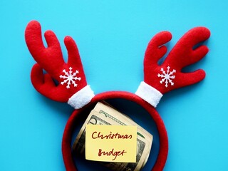 Red reindeer headband cash dollars money on blue background with text note written CHRISTMAS...