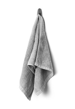 Grey towel hanging on a hook closeup isolated on a white background