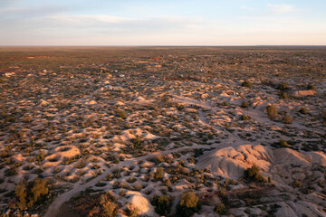 Aerial drone shot of abandoned mine shafts in desert landscape
