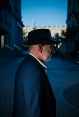 Fototapeta na wymiar Portrait of adult man in suit and hat on street. Madrid, Spain
