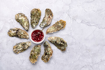 Fresh oysters with sauce and lemons