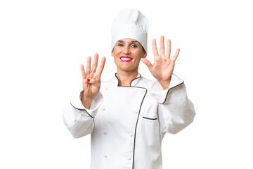 Middle-aged chef woman over isolated background counting nine with fingers