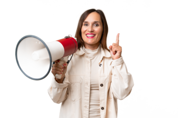 Middle-aged caucasian woman over isolated background holding a megaphone and pointing up a great idea