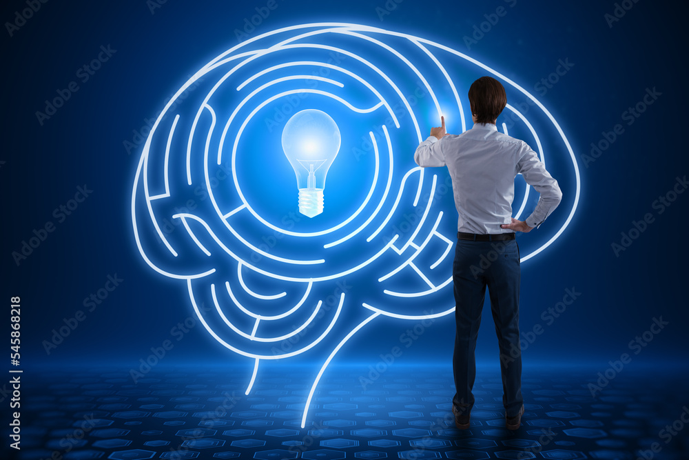 Poster back view of young european man using abstract digital light bulb with human brain inside glowing on