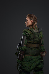 Photo of brown haired female soldier dressed in protective uniform and gas mask.
