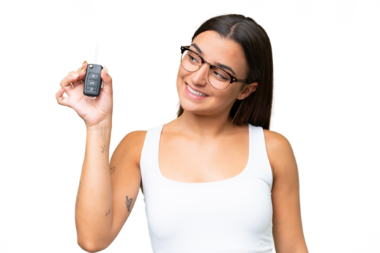 Young caucasian woman holding car keys isolated on green chroma background background with happy expression