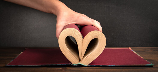 Book reading, learning and skill concept. Sheets of paper in the shape of a heart