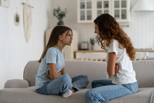 Angry Young Woman Mother Having Disagreement With Troubled Teen Girl, Disrespectful Child Daughter Arguing Quarreling With Mom At Home. Conflict Between Parents And Teenagers, Problems Of Adolescence