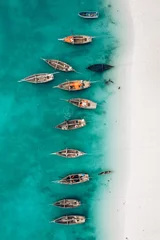 Deurstickers Top view or aerial view of Beautiful crystal clear water and white beach with long tail boats in summer of Zanzibar island © olyphotostories