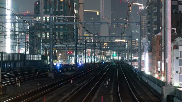 Time lapse of rush hour commuter trains at night in Tokyo, Japan