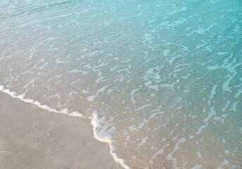 Wave of blue ocean on sandy beach. Background